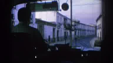 Spain (1966): Tour Bus Driver Looking Out Window At A Castle On The Hill Above A