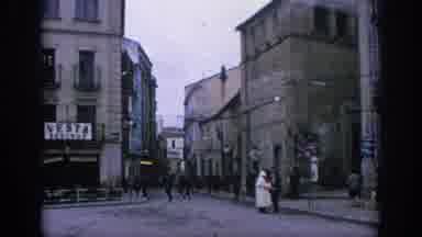 SPAIN-1966: Scenes Of People Walking Around Old Stone Village Shops And Homes