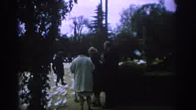 Spain (1966): Many White Doves Surrounding An Older Woman Outside In A Forest