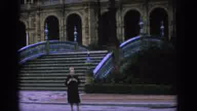 SPAIN-1966: Tourist in Black Dress Photographing Plaza de España