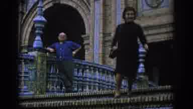 Spain (1966): A Woman Walking Down Some Stairs And Taking The Hand Of A Nearby Man