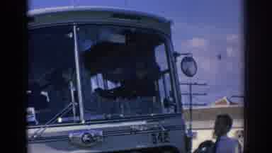 Spain (1966): Two Men Assessing Windshield Damage To A Passenger Bus As A Train