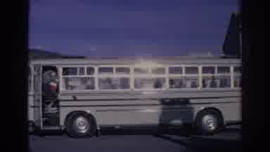 Spain-1966: School Bus Stops Outside Brass Metal Shop As Woman Shops