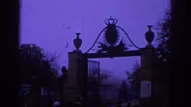 Spain (1966): Somber Park With Statue Illuminated By A Purple Hazy Evening Sky