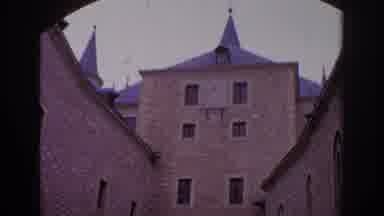 Spain (1966): Large Brick House With Several Vertical Windows Spread Across Its