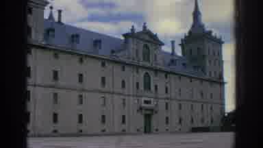 Spain (1966): An Old Building Has Statues And Spires On Its Roof And A Paved Yard