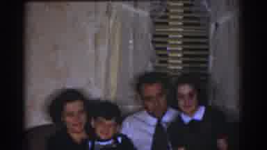 Omaha Nebraska USA (1968): A Man Looks On At A Mother, Father And Children Sitting