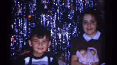 Omaha Nebraska USA (1968): A Girl Holding Dols And A Boy Pretending To Take A