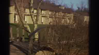 Bedford Virginia USA-1971: A Pan Across Apartment Buildings Through Bare Trees