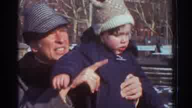 Bedford Virginia USA (1971): Man Holding Child Up Gesturing And Talking