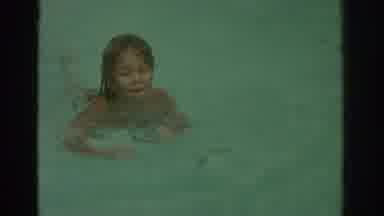 Miami Florida USA (1971): A Young Child Swimming In A Pool With His Mom Watching