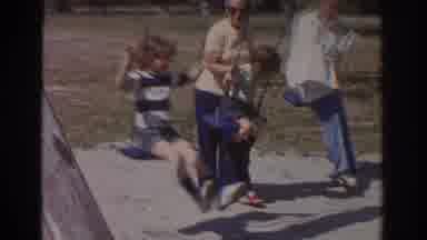 Miami Florida USA (1971): Children Swinging While One Is Being Pushed By A Woman