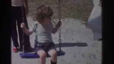 Miami Florida USA (1971): Little Boy And Old Woman Swinging Happily On A Swing Set