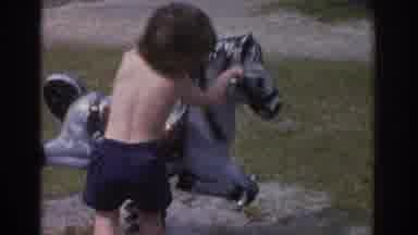 Miami Florida USA (1971): Little Boy And Friend Trying Riding A Horse Toy