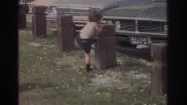 Miami Florida USA (1971): Boy Playing In Front Of Parked Cars On A Beautiful Sunny