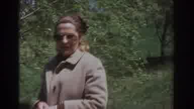 Richmond Virginia USA (1971): Woman In Coat Sunglasses Walking Towards Fenced
