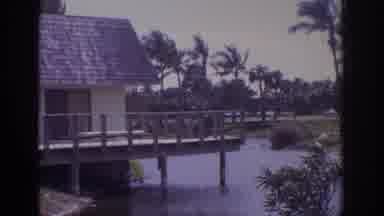 Naples Florida USA (1973): House On Stilts Over A River Alongside A Large Building