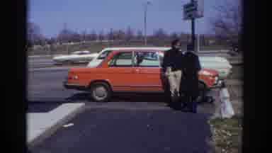 Philadelphia Pennsylvania USA (1973): Couple Outside On Parking Lot With Newspaper