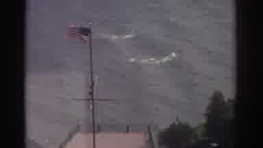 Cleveland Ohio USA (1974): Flags Blowing In Wind By Pier And Tall Building With