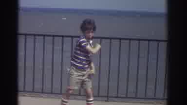 Cleveland Ohio USA (1974): Boy Simulates Baseball Play And Runs After The Ball As