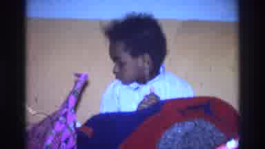 Atlanta Georgia USA (1975): Little Boy Sitting At The Couch Looking Around And