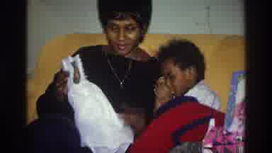 Atlanta Georgia USA (1975): Sister Making Her Brother To Play With The Toy