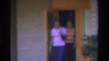 Atlanta Georgia USA (1975): Women Leave House Through Orange Wooden Door Wave At