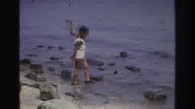 Atlanta Georgia USA (1975): A Kid Is Playing In The Water Near The Shore With Lot