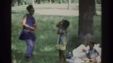 ATLANTA GEORGIA USA-1975: Family Picnic With Children Dancing In Park