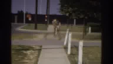 Atlanta Georgia USA (1975): Man Walking Then Young Girl Running Near A Road On