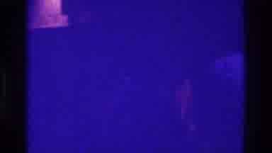 Bronx New York USA (1975): Man Wearing White Shirt Walking Through A Dimly Lit