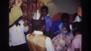 Bronx New York USA (1975): Older Girl Encourages All The Little Children In Party
