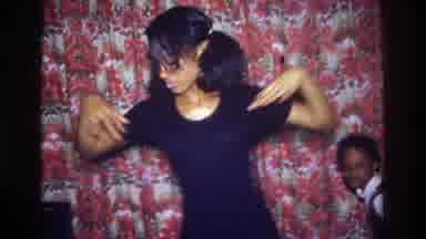 Bronx New York USA (1975): Woman Dances In A Silly Fashion In Front Of Her Kid