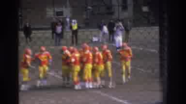 Bronx New York USA (1975): Orange Football Players Huddle On Football Field White