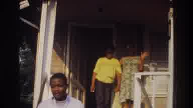 Washington DC USA (1975): A Woman And Boy Stand On A Porch As The Woman Waves