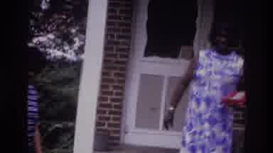 Washington DC USA (1975): A Black Woman Steps Down Off The Porch Of A Brick Home