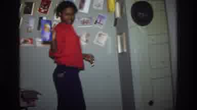 Washington DC USA-1975: Young Woman Arranging Photos On Wall In Vintage Home Movie