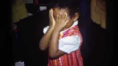 Washington DC USA (1975): Child Covers Her Face Playfully At Social Gathering
