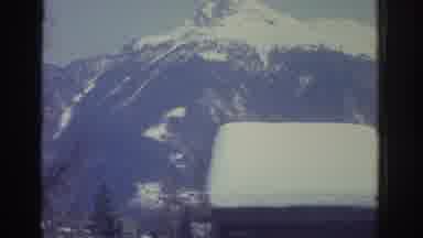 Bern Switzerland (1976): Snowy Mountain Close To A Small Village Covered In Snow