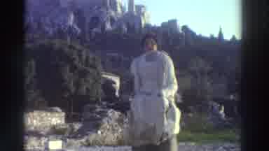 Greece (1976): Lady Standing Behind A Broken Statue Pretending It Is Her