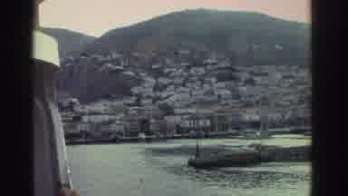 Greece (1976): A Wharf Area Has Several Boats And A Fire Burns In A Pit