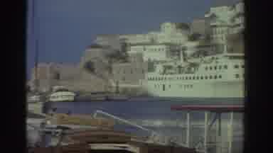 Greece (1976): Ships And Various Buildings On A Mediterranean Coastline
