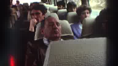 Greece (1976): People Relaxing On A Bus During A Scenic Road Trip Past A Body Of