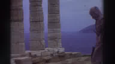 GREECE-1976: Man Walking Through Open Ancient Pillar Ruins Turns And Faces The Camera