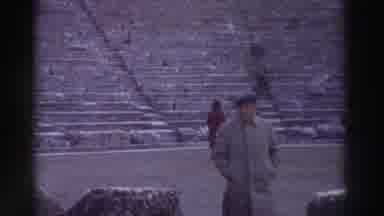 GREECE-1976: Tourists Explore Ancient Ruins With Stone Columns And Amphitheater Steps