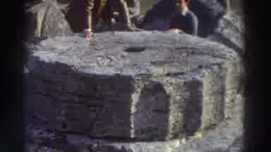 GREECE-1976: A Man And Woman Study The Bottom Piece Of An Ancient Column Amidst Ruins