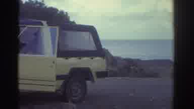Greece (1976): View Of Yellow Car, Cobblestone Cottage Streets Next To White Brick