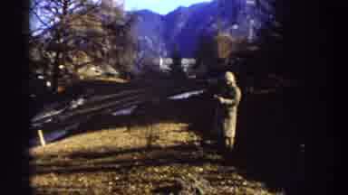 Greece (1976): Person Standing Wearing A Trench Coat Shows The Mountain Range In