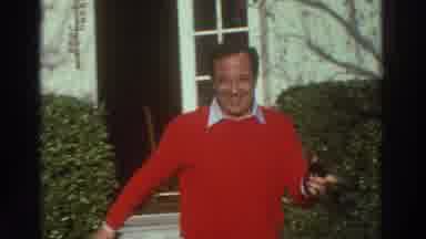 GREECE-1976: Man Wearing Red Sweater Smiles While Walking in Garden