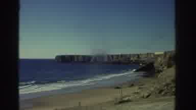 GREECE-1976: Waves Crash On The Beach Along A Cliff Shore Line